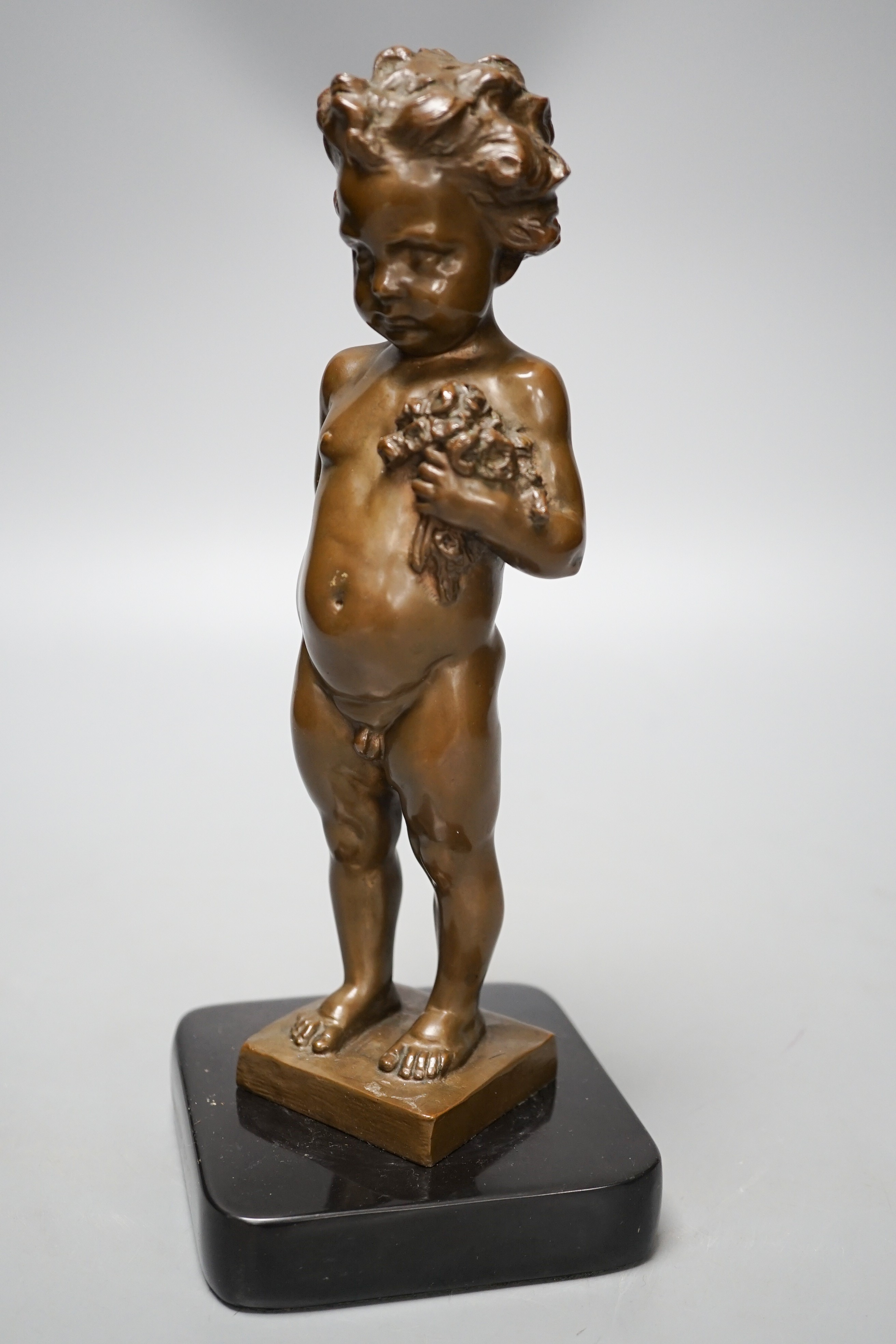 A bronze of a putto holding flowers, signed ‘M.Müller’ 25cm